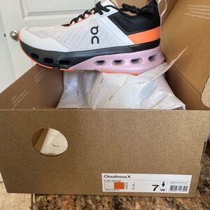 On Running Cloudnova X in White, Black, and Orange